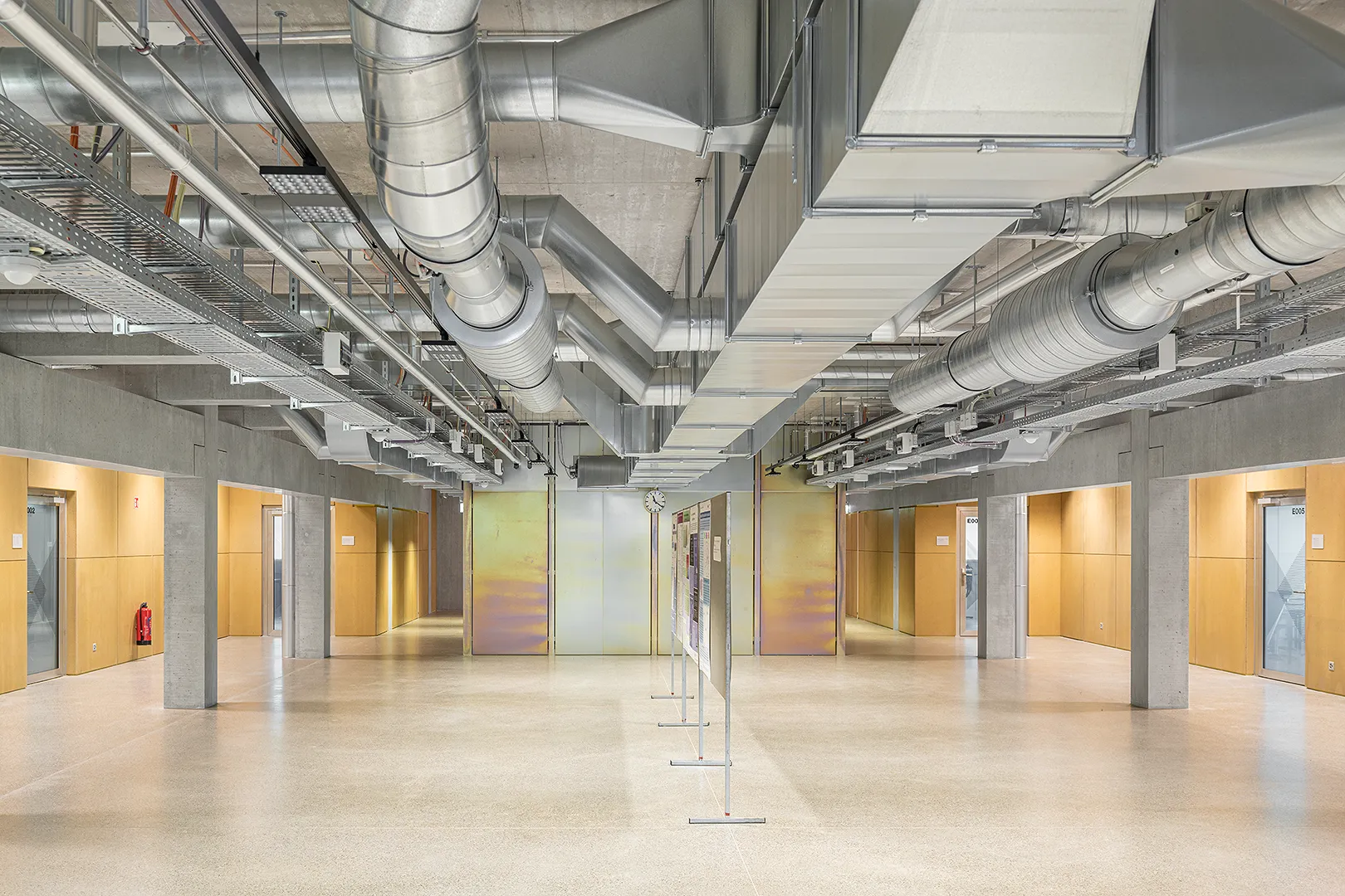 Architecture Photography of a modern brutalist-style school buildings, Kantonsschule Limmattal, featuring light gray-brown recyled-concrete facades, interior view with prefabricated concrete structure by ingegneri pedrazzini guidotti, designed for PENZISBETTINI in Urdorf, Zürich.