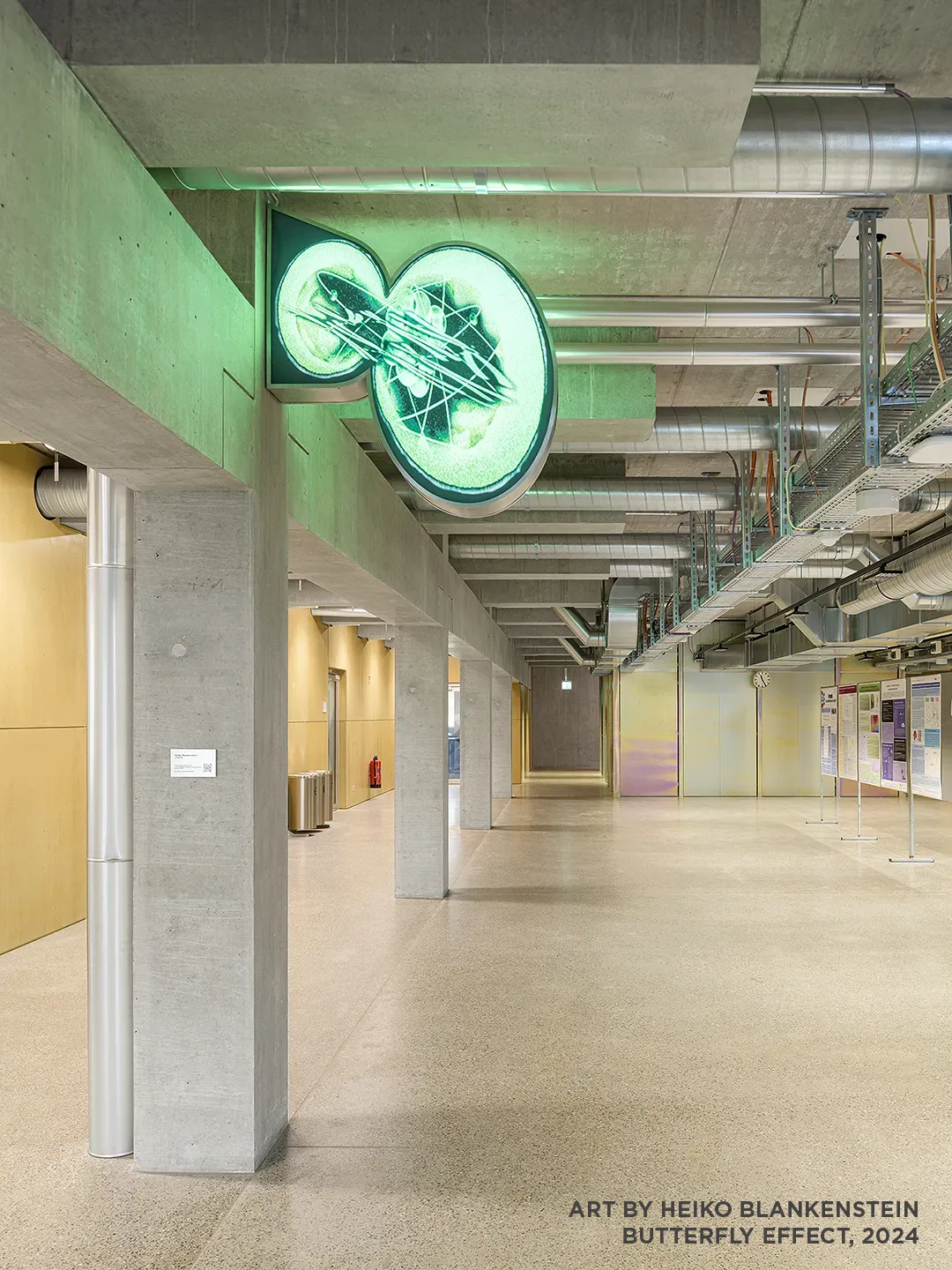 Architecture Photography of a modern brutalist-style school buildings, Kantonsschule Limmattal, featuring light gray-brown recyled-concrete facades, interior view with prefabricated concrete structure by ingegneri pedrazzini guidotti, designed for PENZISBETTINI in Urdorf, Zürich. Art in display by Meiko Blankenstein, butterfly effect, 2024.
